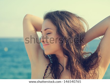 Beautiful Woman Face With Closed Eyes On Blue Sea Background. Closeup