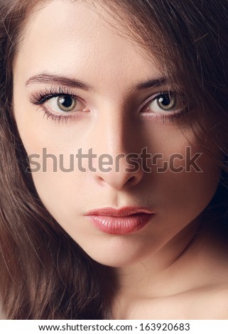 Beautiful woman face with green eyes. Vintage closeup portrait