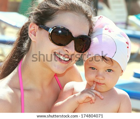 Smiling mother and baby with fun face. Closeup portrait of happy beautiful family