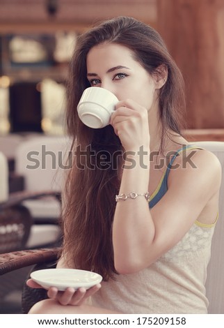 Beautiful thinking girl drinking coffee. Closeup vintage portrait