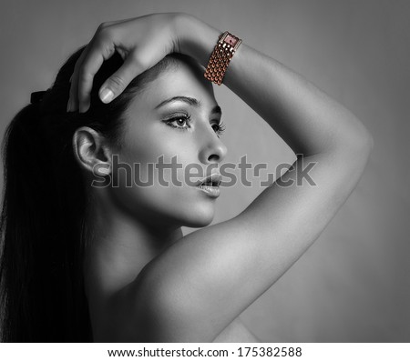 Sexy beautiful woman with modern watch on the hand. Black and white portrait