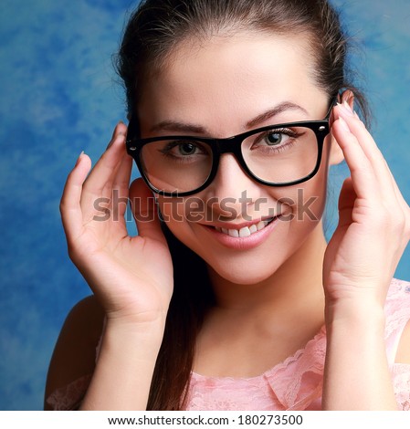 Beautiful woman in glasses looking happy. Closeup portrait