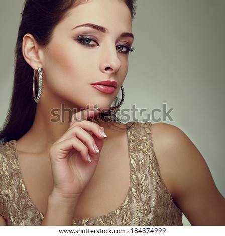 Art portrait of fashion makeup female model with modern earring. Closeup