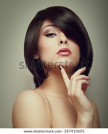 Sexy beautiful makeup woman with hand under face. Closeup vintage portrait