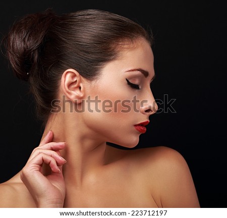 Beautiful makeup woman profile with elegant hairstyle. Closeup portrait on black