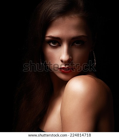 Sexy woman looking on dark black background. Art closeup portrait
