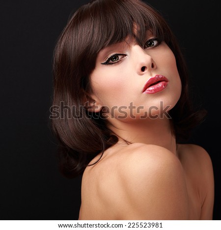 Beautiful makeup woman with short hairstyle. Closeup on black background
