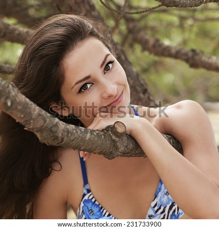 Beautiful smiling woman with romantic look outdoors park background. Closeup portrait