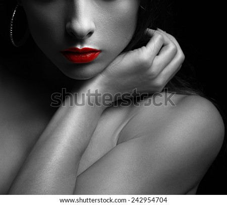 Black and white art portrait of sexy woman with red glossy lips on dark. Closeup