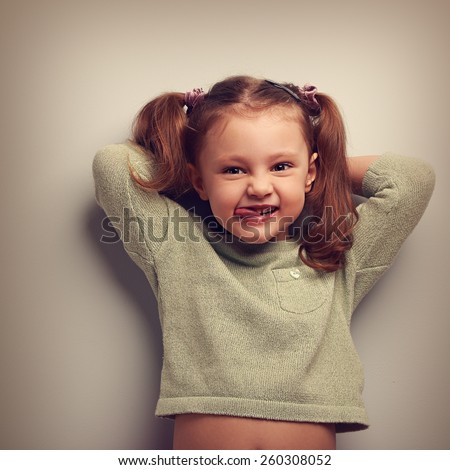 Happy kid girl with natural emotion in fashion blouse. Vintage closeup portrait