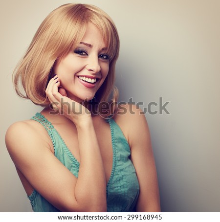 Happy smiling casual blond woman with short hairstyle. Toned closeup portrait