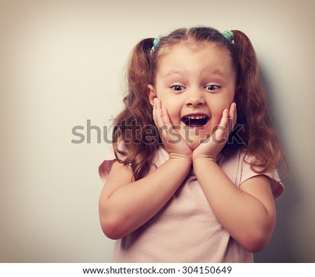 Happy very excited kid girl with open mouth looking. Closeup vintage portrait