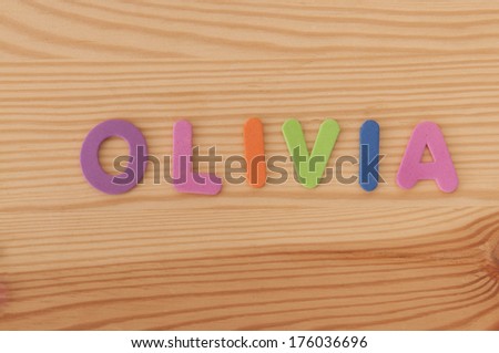 The Female name Olivia made from foam letters on a wooden background
