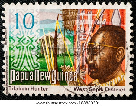 PAPUA NEW GUINEA - CIRCA 1973: A used postage stamp from Papua New Guinea illustrating a tifalmin hunter, issued in 1973.
