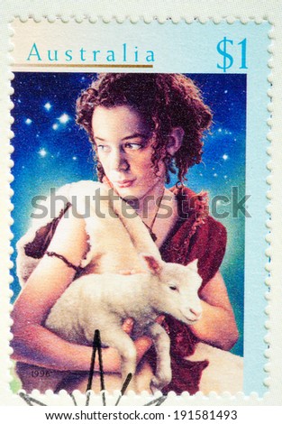 AUSTRALIA - CIRCA 1996:A Cancelled postage stamp from Australia illustrating shepherd and lamb, issued for Christmas 1996.