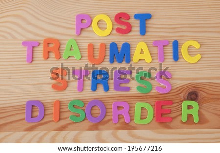 Foam letters spelling out post traumatic stress disorder on a wooden background