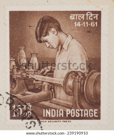 INDIA - CIRCA 1961: A Cancelled postage stamp from India illustrating a boy making pottery, issued in 1961.
