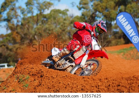 Motocross Rider powering out of a corner