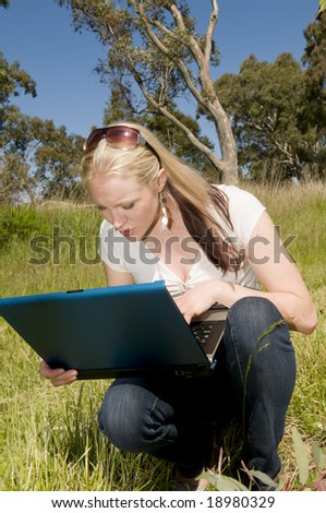 Young Woman using laptop in rural setting