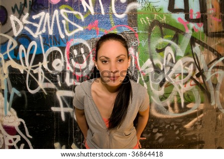 Photo of attractive young woman against a graffiti background