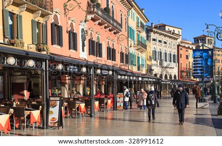 Verona, Italy -  January 28, 2015: Many tourists on Piazza Bra in Verona, Italy - tourist and trading place of the city