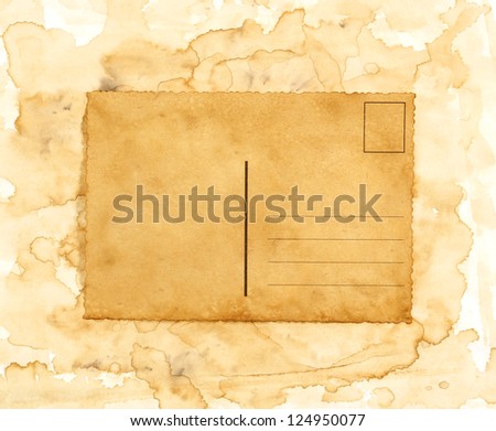 Blank old postcard on  spilled paint background
