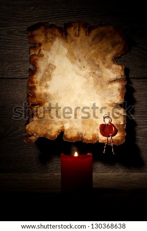 Old vintage paper with seal stamp and candle light