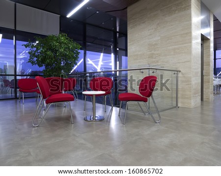 Red meeting chairs in office building