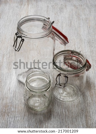 Empty, opened jars on wooden background