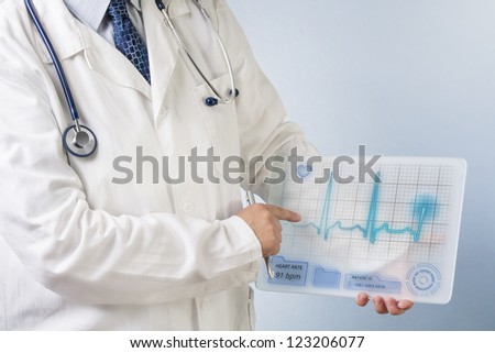 Doctor showing ECG data on futuristic transparent tablet.