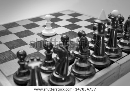 Single pawn facing many enemies as a symbol of difficult unequal fight or struggle of minorities.