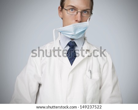 Young doctor tired after complicated surgery or confused because of complicated problem.