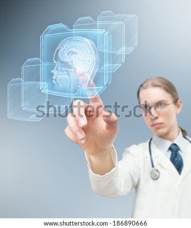 Doctor pushing futuristic virtual button and performing magnetic resonance of human brain.