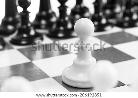 Single pawn against many enemies as a symbol of difficult unequal fight or struggle.