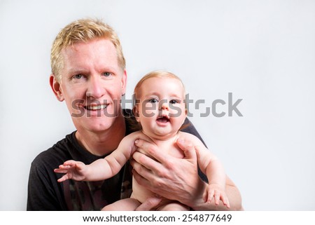 Father holding sweet smiling baby girl