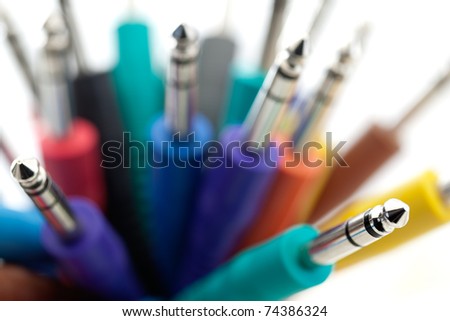 An array of colorful 1/8 inch patch cords with very shallow depth of field.