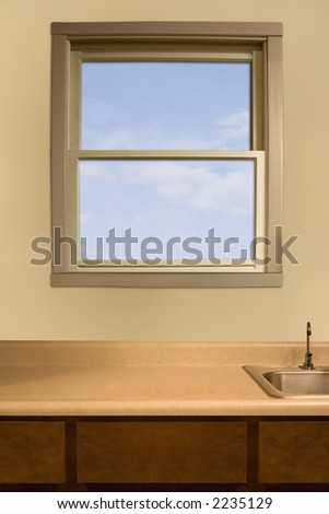 a kitchen window over an empty counter top