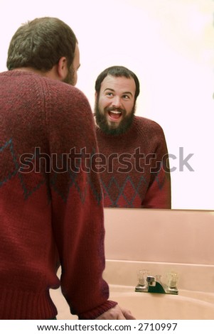 a man looking into a mirror and smiling
