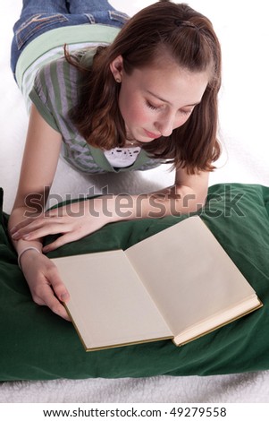 a young teenage girl reading a book