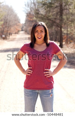 a beautiful young girl standing outside with a shocked expression