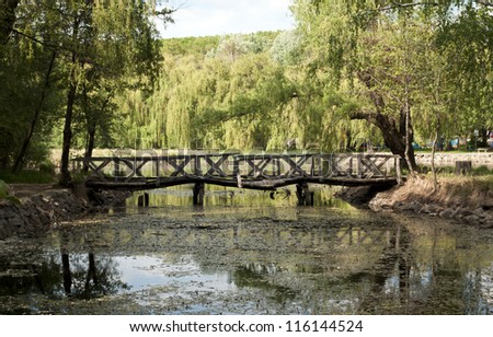 Old rickety Wooden Bridge over the Lake