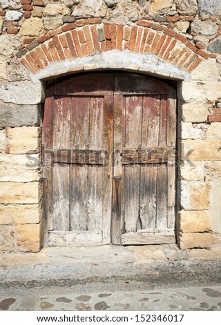 Ruined wooden Door from the Street in Italy