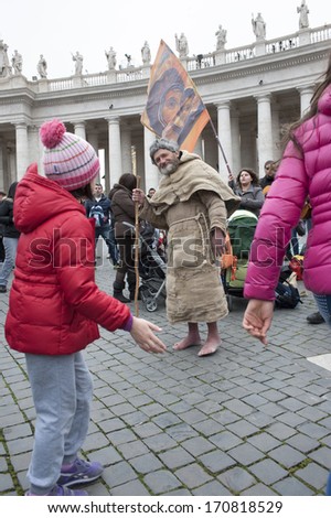 Vatican City, Rome, Italy - March 17, 2013: Man sings surrounded by pilgrims in St. Peter\'s Square.