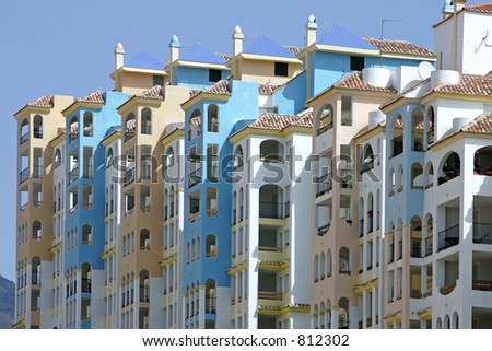 Row of colorful sunny brand new apartments for sale in Estepona Spain on the Costa del Sol