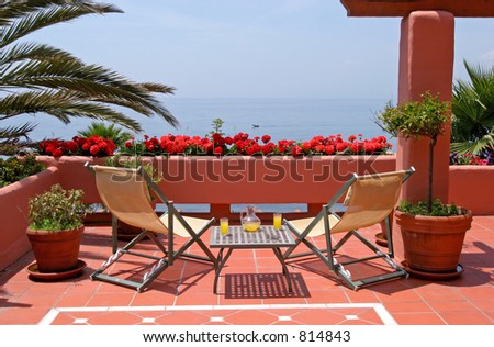 Terrace, table, chairs of luxury apartment and sea views to the mediterranean sea in Spain