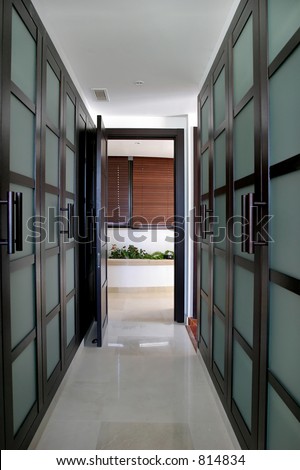 Converging lines of green walk in wardrobes in a large luxurious Spanish villa that is for sale. Real estate.