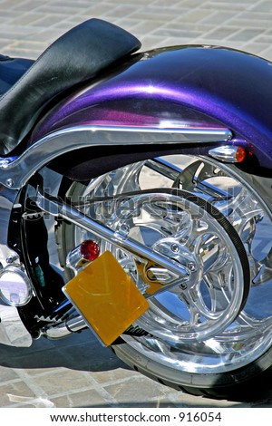 Beautiful purple rear end and wheel of custom chopper motorbike with fan drive and blank numberplate