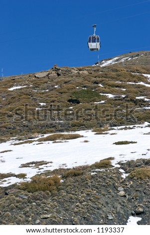Single cable car on way up mountain of ski resort in Spain