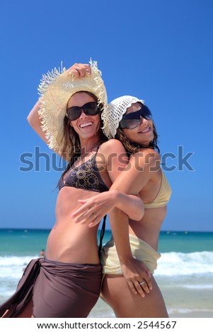 stock photo : Two sexy fit and tanned young girls or friends playing on a 