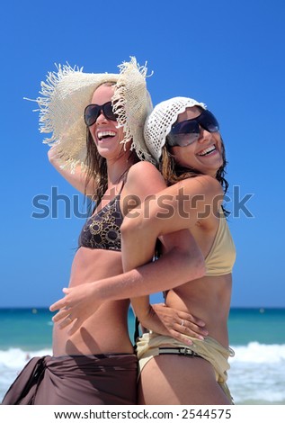 stock photo : Two sexy fit and tanned young girls or friends playing on a 